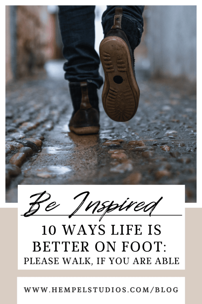 A pinnable image of person wearing duck boots and walking on a wet cobblestone street. The text says, "Be Inspired. 10 Ways Life is Better on Foot: Please Walk, if You Are Able." www.HempelStudios.com/blog
